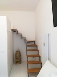 a staircase in a room with white walls at BED and BIKE - BERGAMO Old Town in Bergamo