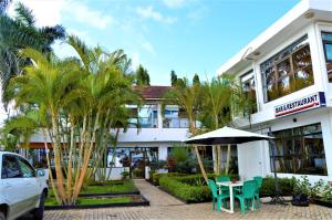 a building with a table and chairs in front of it at M Hotel in Dar es Salaam