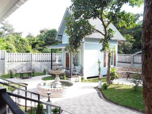 a patio with a fountain in front of a house at Sky cottage in Ko Samed