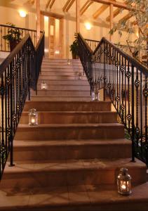 a set of stairs in a building with lights at Atrium Agárd Panzió in Gárdony