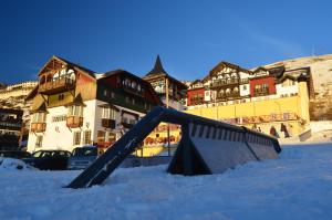 a slide in the snow in front of buildings at Hotel GHM Monachil in Sierra Nevada