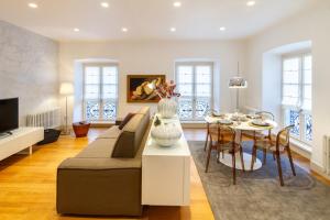 a living room with a couch and a table at Tergesteo Palace Suite in Trieste