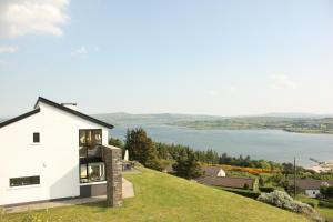 a house on a hill with a view of the water at Sea Vista Boutique Accommodation in Fahan