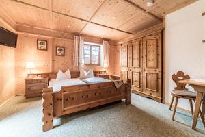 a bedroom with a large wooden bed in a room at LandererMühle in Lenggries