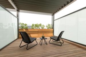 two chairs and a table on a wooden deck at The Fortyfive Business Hotel & Spa in Manisa