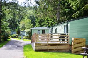 a wooden fence in front of a caravan park at Newby Bridge Country Caravan Park in Newby Bridge