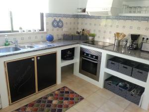 a kitchen with a sink and a counter at Casa Esperanca in Carvoeiro