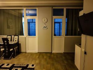 an office with a desk and a clock on the wall at Hotel T Apartment in Gonio