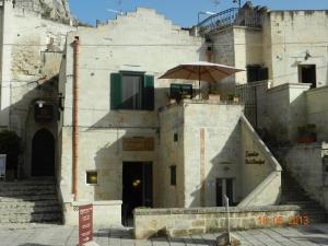 a building with an umbrella on top of it at Sassolino Dimora Storica in Matera