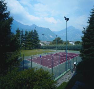a tennis court with two people on it at Hotel Castel Lodron in Storo