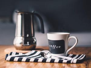 a coffee cup sitting on top of a wooden table at Casita Picaflor in Punta del Este