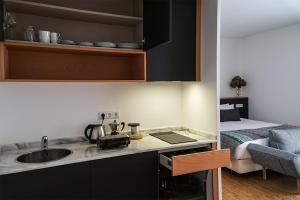 a kitchen with a sink and a bed in a room at Furnas Lake Forest Living in Furnas