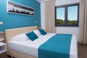 Posteľ alebo postele v izbe v ubytovaní Aparthotel Punta Blu - POOL & SPA