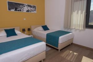 Posteľ alebo postele v izbe v ubytovaní Aparthotel Punta Blu - POOL & SPA