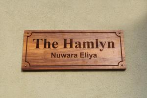 a sign on a wall that reads the humanity niangua elivo at The Hamlyn in Nuwara Eliya