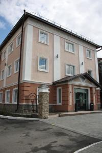 a large brick building with a garage at Avenue Park Hotel in Kurgan