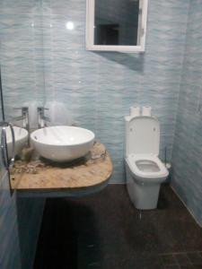 a bathroom with a sink and a toilet at Corner Bay Apartments Beau Vallon,Mahe in Victoria
