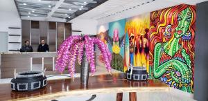 a room with a wall with a colorful painting at Hotel Festival Plaza Playas Rosarito in Rosarito