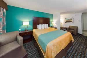 um quarto de hotel com uma cama grande e um sofá em Sunset Motel Hood River em Hood River