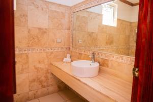 La salle de bains est pourvue d'un lavabo sur un comptoir en bois. dans l'établissement Pato Canales Hotel & Resort, à San Luis