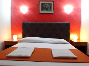 Postel nebo postele na pokoji v ubytování Hotel Arcella