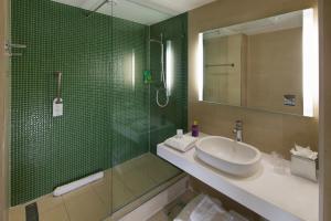 a bathroom with a sink and a mirror at The Orchard Hotel & Restaurant in Nottingham