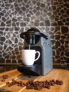 a coffee machine sitting on a wooden table with a cup at COSY & NATURAL *FIREPLACE*GARDEN*2 BIKES in Heinenoord