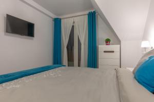 Posteľ alebo postele v izbe v ubytovaní Apartament Podwika
