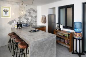 a kitchen with a large counter and a refrigerator at Villa Robalo A in Sayulita +11 photos