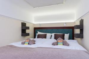 uma grande cama branca com duas almofadas em Jungle design apartment em Budapeste