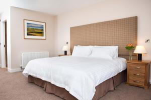 Postel nebo postele na pokoji v ubytování The Lodge at Craigielaw and Golf Courses