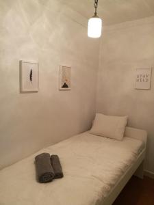 a bed in a room with two pillows on it at Santa Marta Apartment in Lisbon