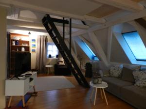 a living room with a couch and a ladder at Blue Wall BnB in Gebenstorf