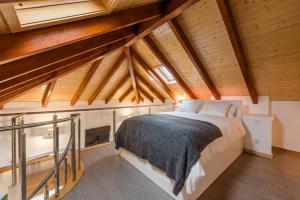 a bedroom with a large bed in a attic at SOBRI Cork House - Sustainable Loft in Porto