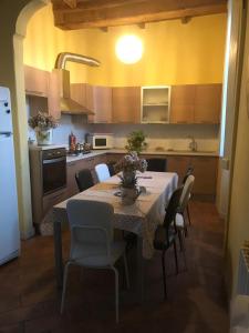 a kitchen with a table and chairs in a kitchen at Villa L' Antico Torchio in Dormelletto