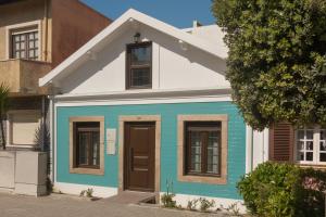 a blue and white house on a street at Vivenda Golfinho Barra in Praia da Barra