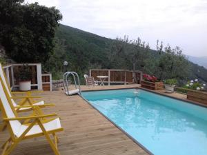 a swimming pool on a wooden deck with a view at Villa L'Oliveto in Trevi