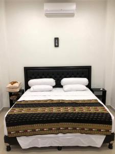 a bedroom with a bed with a quilt on it at Vila Troja Kubu in Tulamben