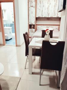 a dining room with a table and chairs and a bed at J&B - Beachside Studio Apartment in Makarska +13 photos
