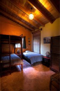 a bedroom with a large bed and a lamp at Casa Wenche in Santa Cruz La Laguna