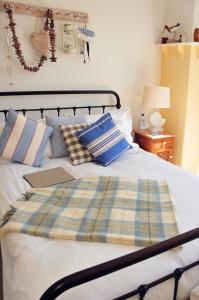 a bed with a laptop sitting on top of it at Lulworth Cove Inn in Lulworth Cove