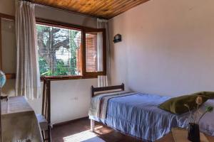 a bedroom with a bed and a window at Hospedaje La Casa del Ceibo in Córdoba +48 photos