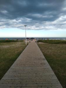a brick path leading to the beach with a light pole at Casa na praia in Itapoa +6 photos