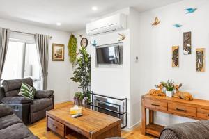 a living room with a couch and a table at Olinda Two Bedroom Apartment - B2 in Olinda