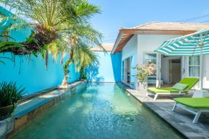 a swimming pool in the backyard of a villa at THE CABANA in Sanur