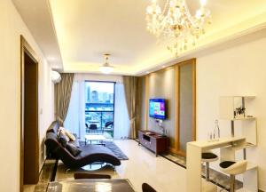 ジョホールバルにあるRnF Princess Cove Luxurious Condoのソファとシャンデリアのあるリビングルーム
