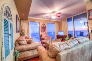 a living room with two couches and a television at Tidewater Beach Resort 1818 By Aneliya in Panama City Beach