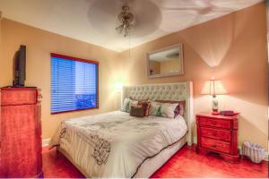a bedroom with a bed with a dresser and a window at Tidewater Beach Resort 1818 By Aneliya in Panama City Beach