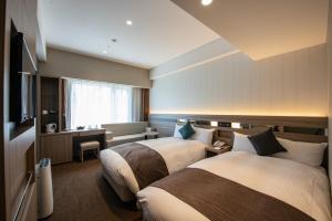 Кровать или кровати в номере Hotel Hewitt Koshien