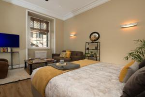 a bedroom with a large bed and a living room at Marvellous apt near Vatican in Rome